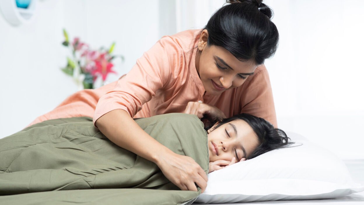 Child sleeping peacefully while wearing orthokeratology contact lenses to control their myopia