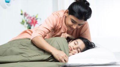 Child sleeping peacefully while wearing orthokeratology contact lenses to control their myopia